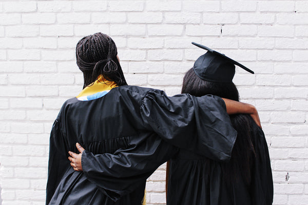 Two Luminary Graduates Hugging
